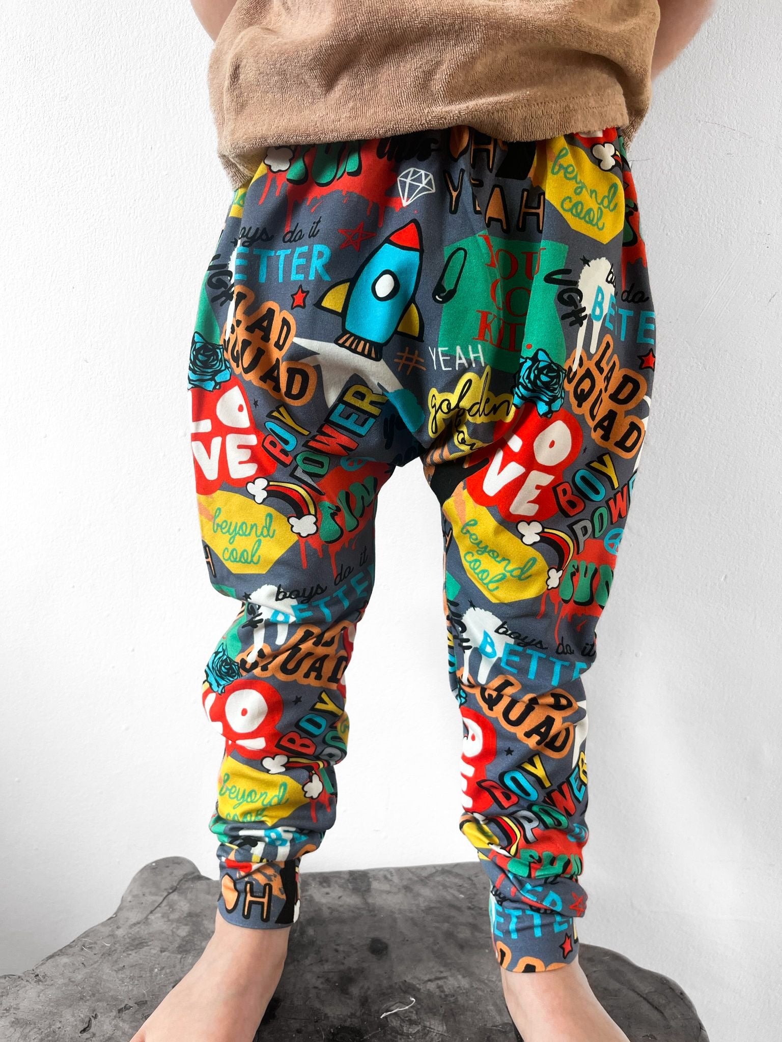 Kids harem pants with colourful graffiti-style slogan and street print