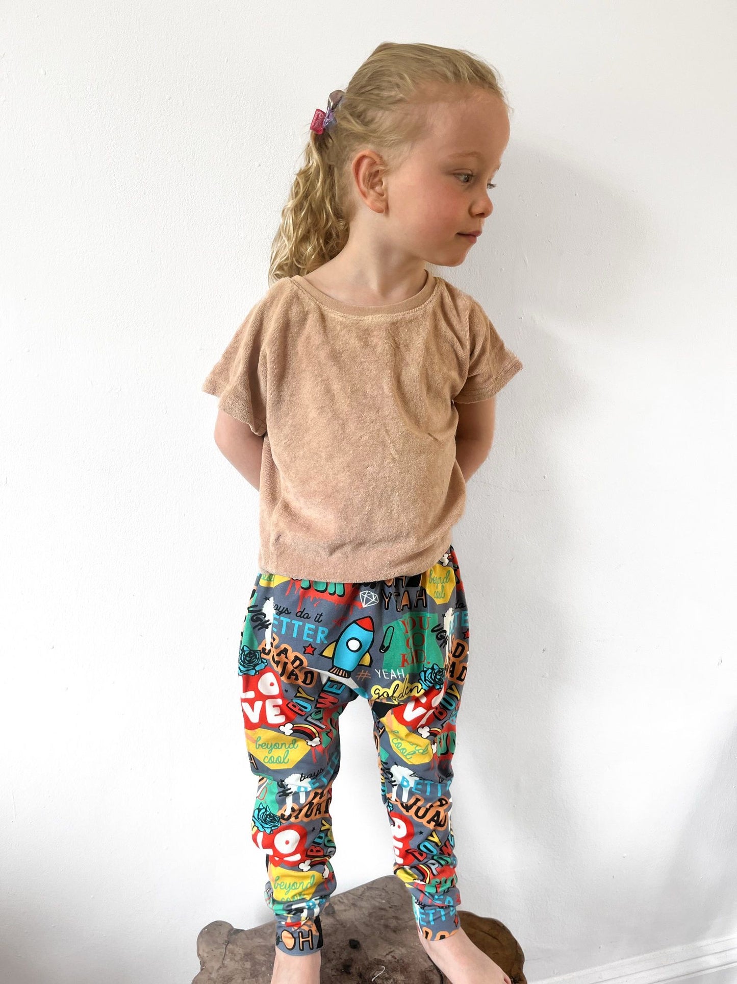 Kids harem pants with colourful graffiti-style slogan and street print